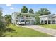 Inviting two-story home with a charming white porch, lush landscaping, and convenient driveway at 5867 Rosewood Dr., Myrtle Beach, SC 29588