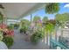 Charming front porch with potted plants, hanging ferns and colorful chairs, perfect for relaxation at 5867 Rosewood Dr., Myrtle Beach, SC 29588