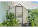 Close-up of a greenhouse on the back deck, perfect for growing plants and enjoying outdoor space at 5867 Rosewood Dr., Myrtle Beach, SC 29588