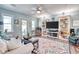 Bright living room featuring a decorative rug, and a custom built-in shelving unit at 5867 Rosewood Dr., Myrtle Beach, SC 29588