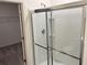 Modern bathroom featuring a glass-enclosed shower with sleek fixtures and a view into the walk-in closet at 606 Muster Field Ct., Conway, SC 29526
