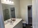 Bright bathroom featuring a large mirror, single sink, and glass shower, creating a spa-like atmosphere at 606 Muster Field Ct., Conway, SC 29526