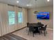 Cozy dining area with modern table, chairs, and a TV, perfect for entertaining and casual meals at 606 Muster Field Ct., Conway, SC 29526