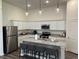 Modern kitchen features stainless steel appliances, white cabinets, and granite countertops, and bar stool seating at 606 Muster Field Ct., Conway, SC 29526