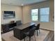 Bright office with a large desk, comfortable chairs, and ample natural light, perfect for a home office at 606 Muster Field Ct., Conway, SC 29526