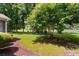 Well-maintained backyard with a mature tree, lawn, and view of a golf course at 6095 Catalina Dr. # 616, North Myrtle Beach, SC 29582