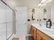 Bright bathroom featuring double sinks, a large mirror, a shower with glass doors, and light wood cabinets at 6095 Catalina Dr. # 616, North Myrtle Beach, SC 29582