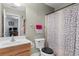 Cozy bathroom featuring a single sink vanity and a toilet with a patterned shower curtain at 6095 Catalina Dr. # 616, North Myrtle Beach, SC 29582