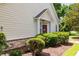 View of a brown front door with landscaping and light yellow siding at 6095 Catalina Dr. # 616, North Myrtle Beach, SC 29582