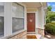 Charming home with a brown front door, adorned with a wreath, and a 'hello sunshine' doormat at 6095 Catalina Dr. # 616, North Myrtle Beach, SC 29582