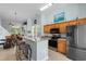 Spacious kitchen features an eat-in bar, stainless steel appliances, and warm oak cabinetry at 6095 Catalina Dr. # 616, North Myrtle Beach, SC 29582