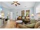 Comfortable living room with a vaulted ceiling, cozy seating, and lots of natural light from large windows at 6095 Catalina Dr. # 616, North Myrtle Beach, SC 29582