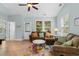 Well-lit living room featuring a comfortable sectional sofa, bright windows, and stylish decor at 6095 Catalina Dr. # 616, North Myrtle Beach, SC 29582