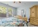 Bright main bedroom featuring two large windows, a decorative bedframe, and an ensuite bathroom at 6095 Catalina Dr. # 616, North Myrtle Beach, SC 29582