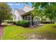 Screened porch with furniture, surrounded by a manicured lawn and lush landscaping at 6095 Catalina Dr. # 616, North Myrtle Beach, SC 29582