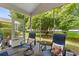 Relaxing screened porch with comfortable seating and views of the green backyard at 6095 Catalina Dr. # 616, North Myrtle Beach, SC 29582