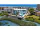 Aerial view showcases a condo complex with a pool, waterway, and ocean background at 6301 N Ocean Blvd. # 2B, North Myrtle Beach, SC 29582