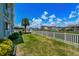Beautiful backyard with well-maintained lawn, white fence, and palm tree at 6301 N Ocean Blvd. # 2B, North Myrtle Beach, SC 29582