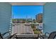Balcony overlooking a parking lot and buildings with blue skies at 6301 N Ocean Blvd. # 2B, North Myrtle Beach, SC 29582