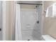 Bathroom featuring a shower and tub with a shower curtain, toilet, and a towel rack at 6301 N Ocean Blvd. # 2B, North Myrtle Beach, SC 29582
