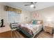 Bedroom showcasing a bed with a colorful patterned duvet, a window, and wooden furniture at 6301 N Ocean Blvd. # 2B, North Myrtle Beach, SC 29582