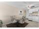 The dining area features a glass table, four chairs and a ceiling fan at 6301 N Ocean Blvd. # 2B, North Myrtle Beach, SC 29582