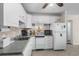 The kitchen features white cabinets and appliances, with a tiled backsplash at 6301 N Ocean Blvd. # 2B, North Myrtle Beach, SC 29582