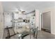A view of the kitchen and dining area with white cabinets and white appliances at 6301 N Ocean Blvd. # 2B, North Myrtle Beach, SC 29582