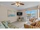 Living room featuring tile floors, ceiling fan, seating and a sliding door to a balcony at 6301 N Ocean Blvd. # 2B, North Myrtle Beach, SC 29582
