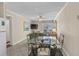 Bright living and dining area with tile floors and access to a balcony with ocean views at 6301 N Ocean Blvd. # 2B, North Myrtle Beach, SC 29582
