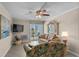 Cozy living area with flat screen TV, ceiling fan, and a sliding glass door leading to a balcony at 6301 N Ocean Blvd. # 2B, North Myrtle Beach, SC 29582