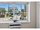 View from the window showing outdoor building and surrounding foliage at 6301 N Ocean Blvd. # 2B, North Myrtle Beach, SC 29582