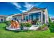 Outdoor living space featuring a stone patio, lawn, furniture, and views of a manicured yard at 6430 Cascata Dr., Myrtle Beach, SC 29572