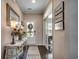 Inviting foyer with hardwood floors, white door, console table, and decor at 6430 Cascata Dr., Myrtle Beach, SC 29572