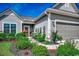 Beautiful home featuring manicured landscaping, gray siding, and a welcoming front entrance at 6430 Cascata Dr., Myrtle Beach, SC 29572
