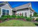 Charming home featuring a well-manicured lawn and decorative floral accents at 6430 Cascata Dr., Myrtle Beach, SC 29572