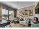 Cozy living room featuring a large window, comfortable seating, and elegant decorative artwork at 6430 Cascata Dr., Myrtle Beach, SC 29572