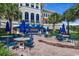 Outdoor patio with blue umbrellas, tables, and chairs at 6430 Cascata Dr., Myrtle Beach, SC 29572