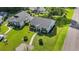 Aerial view of the landscaped front yard and red front door of a well-maintained home at 6570 Pebble Beach Crescent, Myrtle Beach, SC 29588
