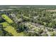 Extensive aerial view showcasing a vast neighborhood, a golf course, and lush green woodlands at 6570 Pebble Beach Crescent, Myrtle Beach, SC 29588
