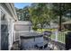 Backyard deck featuring a hot tub, seating, and a view of the wooded lot at 6570 Pebble Beach Crescent, Myrtle Beach, SC 29588