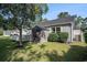 Backyard view featuring a wooden deck, storage shed, lush green lawn, and privacy shrubs at 6570 Pebble Beach Crescent, Myrtle Beach, SC 29588