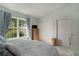 Serene bedroom featuring a large window, closet, and light blue bedding at 6570 Pebble Beach Crescent, Myrtle Beach, SC 29588