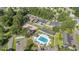 Aerial shot showcasing the community pool, RV parking and tennis courts nestled among mature trees at 6570 Pebble Beach Crescent, Myrtle Beach, SC 29588