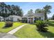 Quaint one-story home with a well-kept lawn and inviting walkway to the front door at 6570 Pebble Beach Crescent, Myrtle Beach, SC 29588