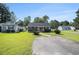 Inviting one-story home with lush green lawn and mature shrubbery. Well maintained property at 6570 Pebble Beach Crescent, Myrtle Beach, SC 29588