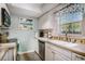 Kitchen with white cabinets, stainless steel appliances, and beach-themed decor at 6570 Pebble Beach Crescent, Myrtle Beach, SC 29588