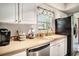 Bright kitchen featuring white cabinets, stainless steel appliances, and window at 6570 Pebble Beach Crescent, Myrtle Beach, SC 29588