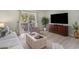 Bright living room with sliding glass doors, comfortable seating, and modern entertainment center at 6570 Pebble Beach Crescent, Myrtle Beach, SC 29588