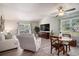 Bright and airy living room with vaulted ceilings, a dining area, and a large window overlooking the yard at 6570 Pebble Beach Crescent, Myrtle Beach, SC 29588